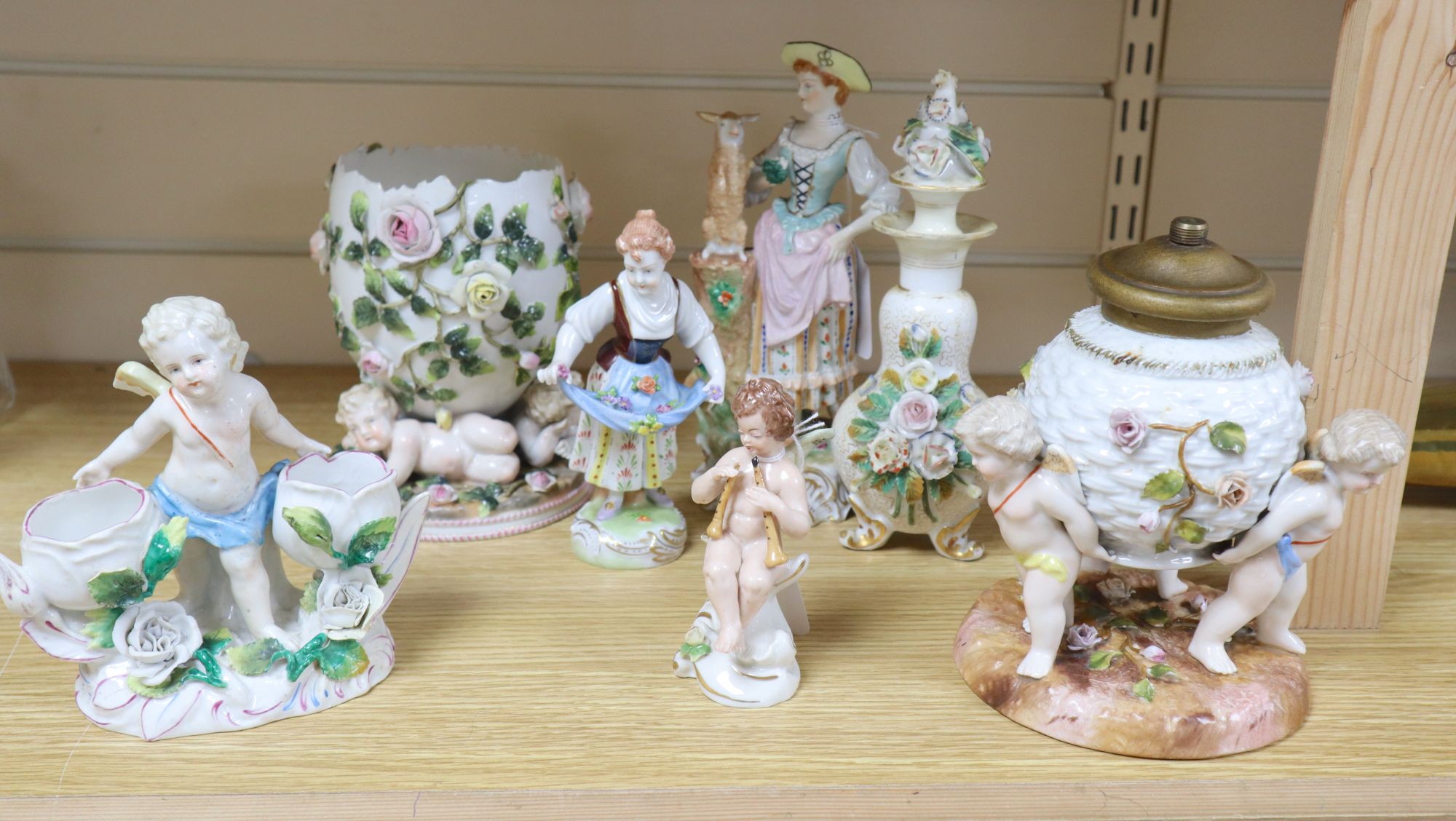 A Sitzendorf flower-encrusted egg-shaped porcelain vase with cherub supports and six other items,